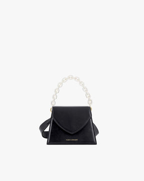 Sac GABRIELLE noir de face, posé, avec anse chaîne courte translucide détachable