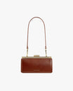 Sac JEANNE BAGUETTE brun, vue de face, porté à l'épaule avec anse longue, fermoir doré fermé