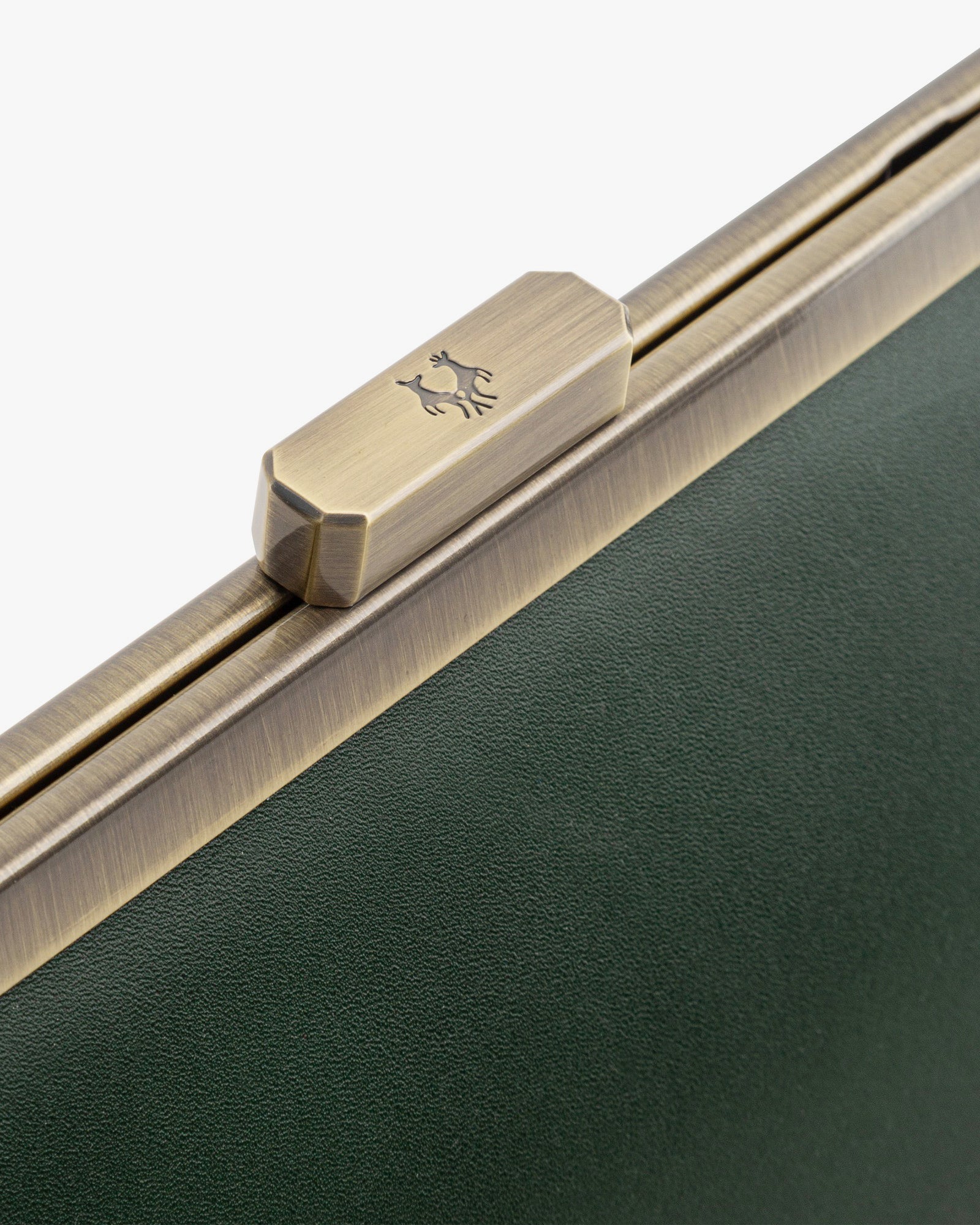 JEANNE BAGUETTE bag in emerald green, close-up on the retro clasp engraved with a deer