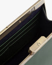 JEANNE BAGUETTE bag in emerald green, open view showing retro clasp and navy interior