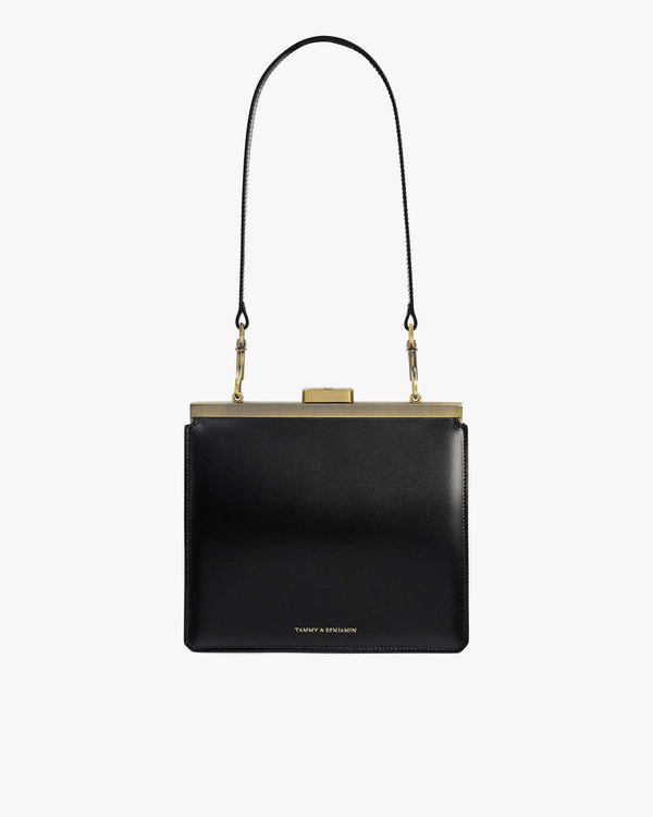 Sac JEANNE en cuir noir, vue de face avec fermoir métallique doré et anse bandoulière détachable