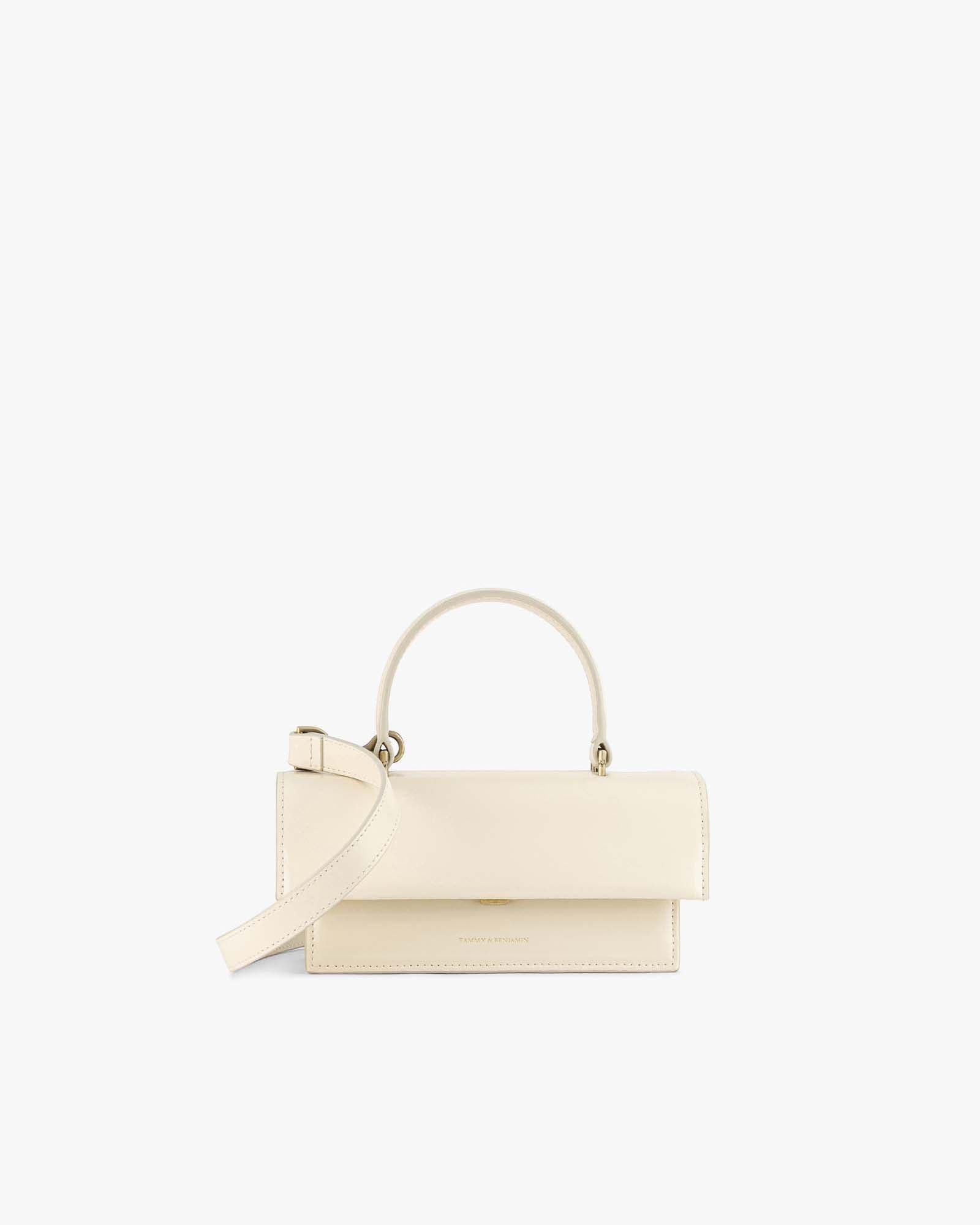 Sac THEA MINI ivoire, vue de face, posé, avec anse courte et bandoulière amovible détachée